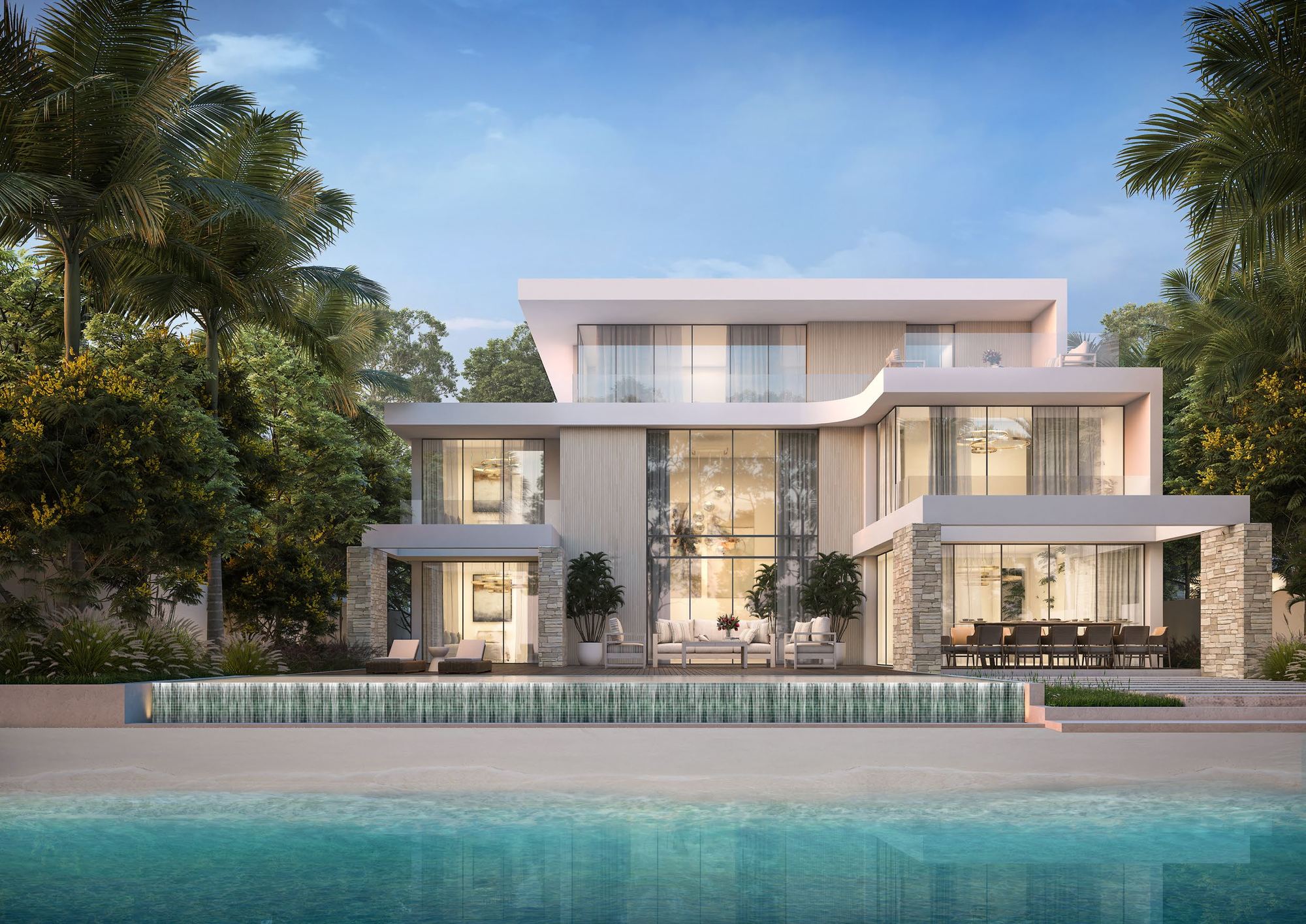 Three-storey white beachfront villa with an infinity pool at dusk (developer render)